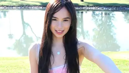 Pale skinned teen Dakota flashes her small tits and shaved pussy outdoors