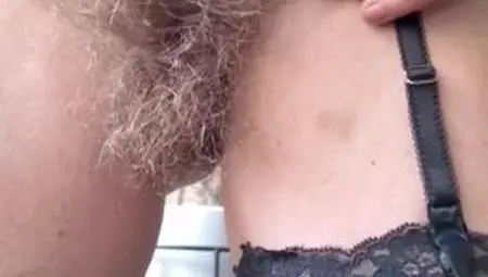 Hairy mature MILF plays with her big bush.