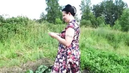 Big Boobed MILF masturbates with cucumber and strawberries outdoor into a outside place