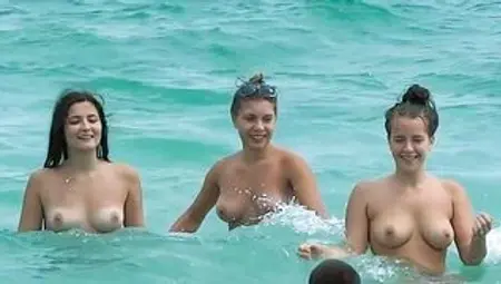 Cute looking young nudists walks on the beach